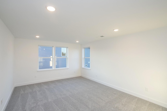 spare room featuring recessed lighting, baseboards, and carpet floors