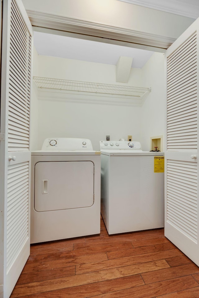 1202 General George Patton Rd, Nashville, TN 37221 - clothes washing area with light wood-type flooring, washing machine and clothes dryer, and laundry area