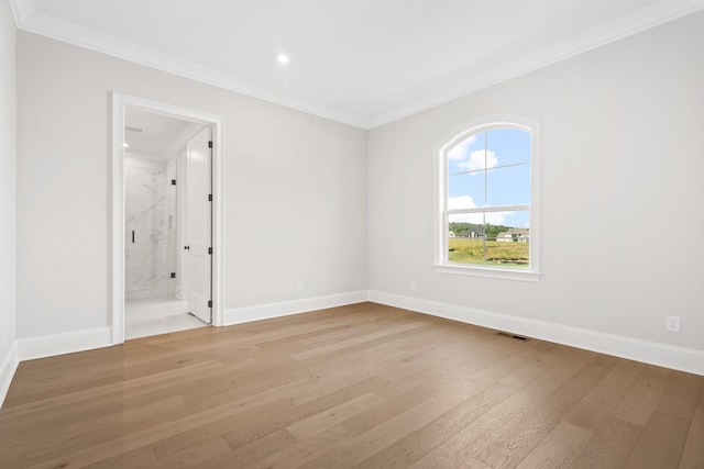 empty room featuring recessed lighting, ornamental molding, light wood-type flooring, baseboards, and visible vents