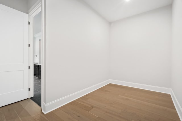 unfurnished room with wood finished floors and baseboards