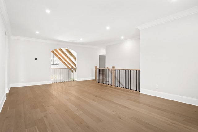 bonus room with light wood-style floors, recessed lighting, arched walkways, and baseboards