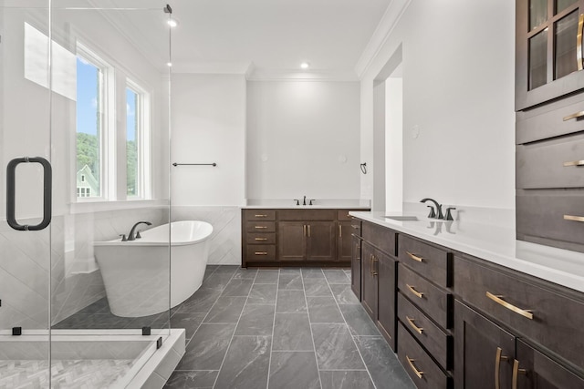 full bathroom with two vanities, a shower stall, marble finish floor, a sink, and crown molding
