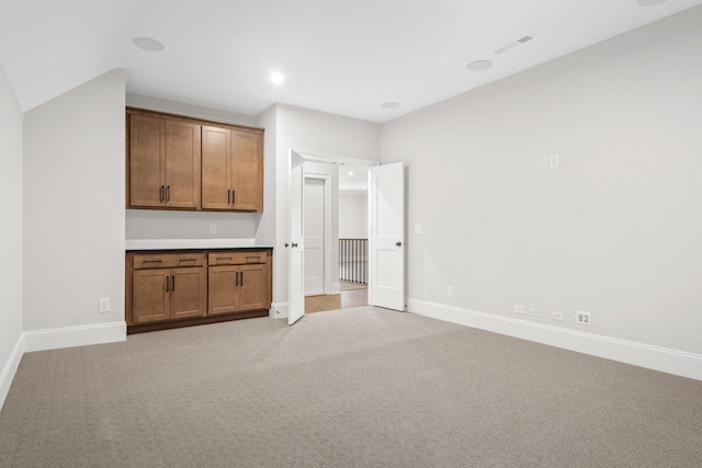 interior space featuring light colored carpet, visible vents, recessed lighting, and baseboards