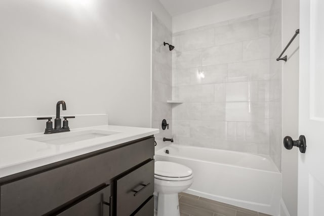 bathroom featuring toilet,  shower combination, and vanity