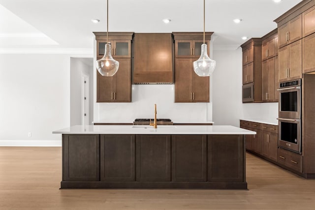 kitchen with light countertops, appliances with stainless steel finishes, and light wood-type flooring