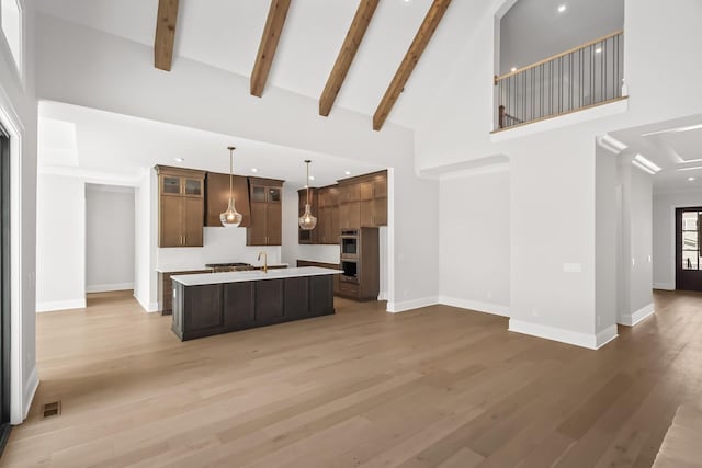 kitchen with baseboards, open floor plan, and light countertops
