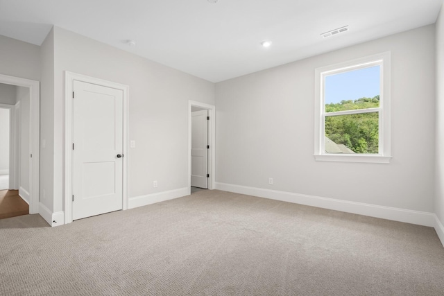 unfurnished bedroom with baseboards, visible vents, and carpet flooring