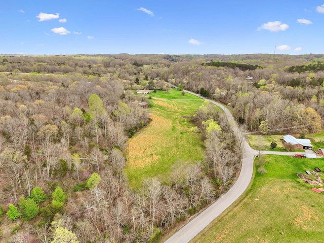 birds eye view of property with a forest view