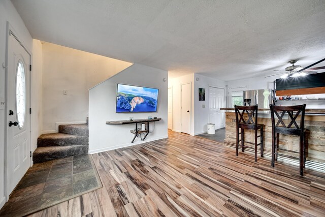 106 Windellwood Cir, Smyrna, TN 37167 - living room with wood finished floors, stairway, a textured ceiling, a ceiling fan, and baseboards