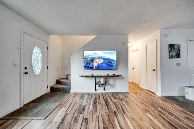 106 Windellwood Cir, Smyrna, TN 37167 - entryway featuring stairway, wood finished floors, a textured ceiling, and baseboards