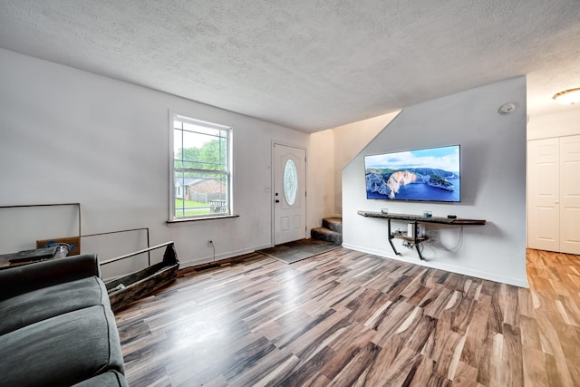 106 Windellwood Cir, Smyrna, TN 37167 - living room featuring wood finished floors, stairway, a textured ceiling, and baseboards