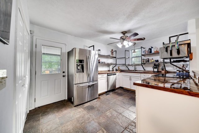 106 Windellwood Cir, Smyrna, TN 37167 - kitchen featuring appliances with stainless steel finishes, open shelves, ceiling fan, dark stone finish floors, and white cabinets