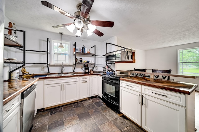 106 Windellwood Cir, Smyrna, TN 37167 - kitchen featuring stainless steel appliances, a textured ceiling, healthy amount of natural light, a sink, and wooden counters