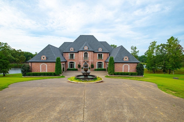 140 Lake Shore Ln, Henderson, TN 38340 - french country style house featuring a front yard, curved driveway, and brick siding
