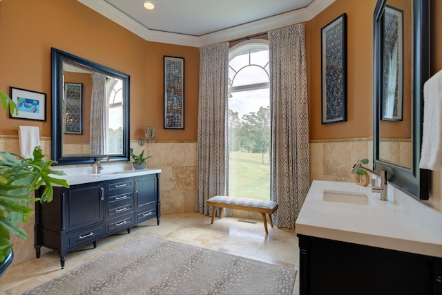 140 Lake Shore Ln, Henderson, TN 38340 - bathroom featuring two vanities, tile walls, a wainscoted wall, a sink, and crown molding