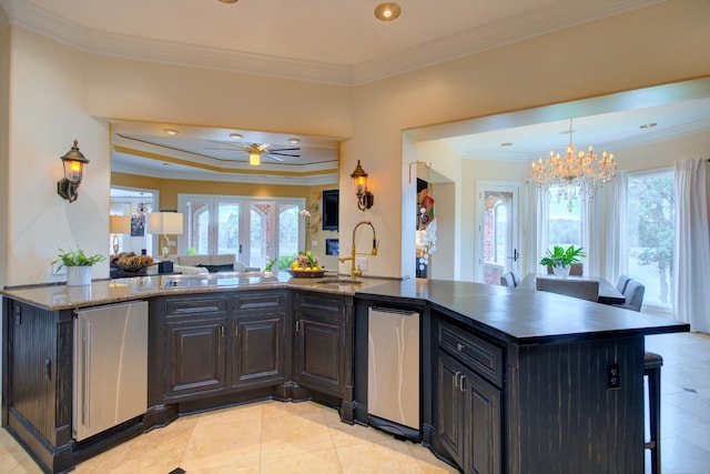 140 Lake Shore Ln, Henderson, TN 38340 - kitchen featuring a sink, a breakfast bar area, ornamental molding, refrigerator, and open floor plan
