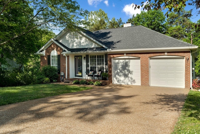 2561 Edinburgh St, Old Hickory, TN 37138 - view of front facade featuring an attached garage, brick siding, a chimney, covered porch, and driveway