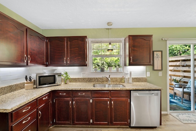 2561 Edinburgh St, Old Hickory, TN 37138 - kitchen with a sink, light stone counters, stainless steel appliances, and reddish brown cabinets