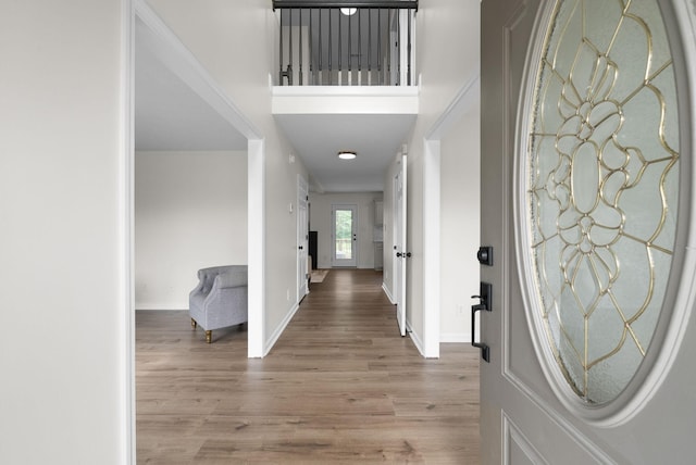 foyer entrance featuring wood finished floors and baseboards