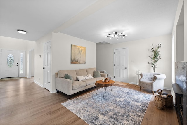 living area featuring baseboards and wood finished floors