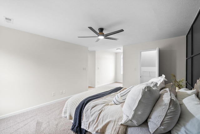 carpeted bedroom featuring baseboards, visible vents, and ceiling fan