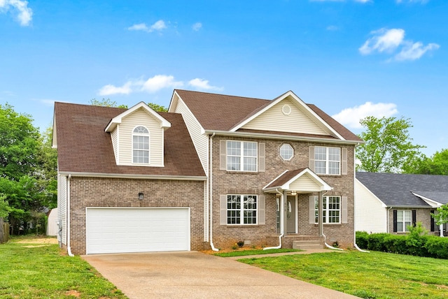 view of front of property with a garage, brick siding, driveway, and a front yard
