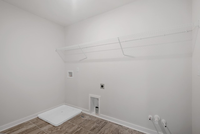 laundry room with hookup for an electric dryer, wood tiled floor, washer hookup, laundry area, and baseboards