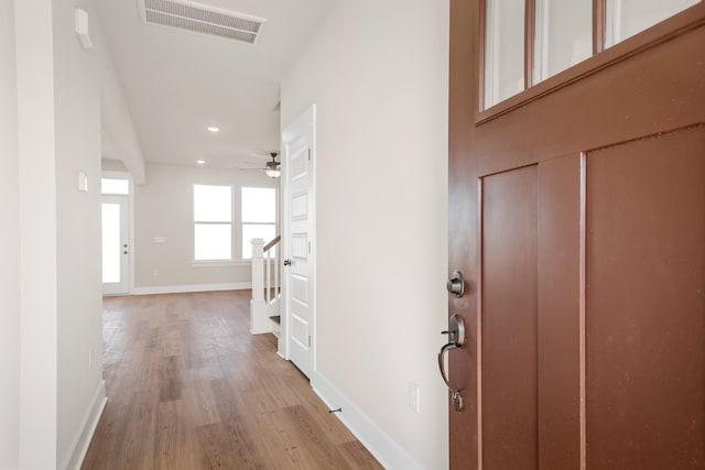 foyer entrance with visible vents, ceiling fan, light wood-style floors, baseboards, and recessed lighting