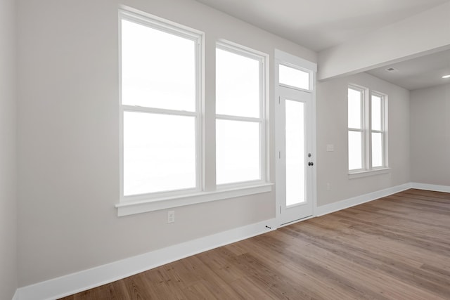 entryway with wood finished floors and baseboards