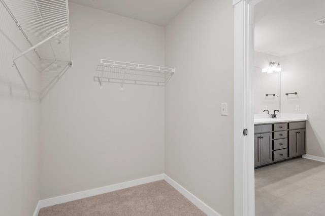 spacious closet featuring visible vents and a sink
