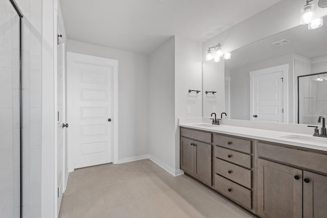 full bathroom with a sink, double vanity, visible vents, a stall shower, and tile patterned floors