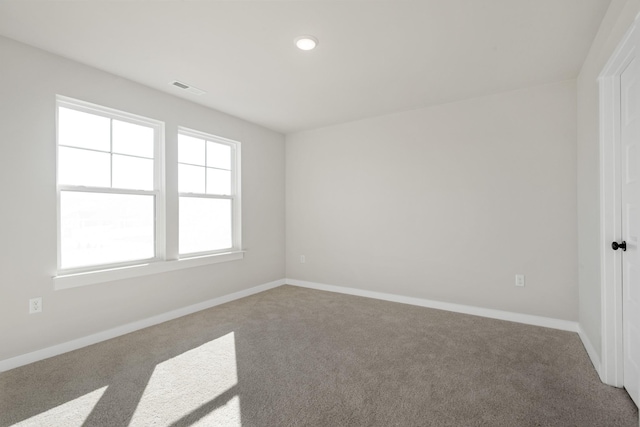 spare room with baseboards, visible vents, carpet flooring, and recessed lighting