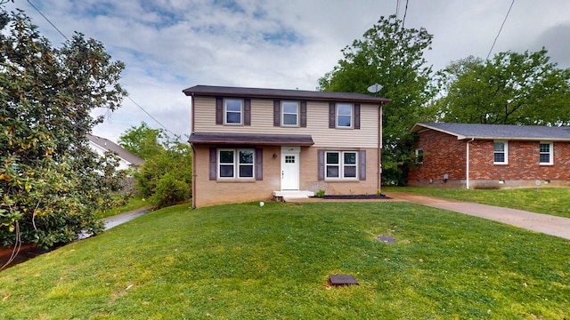 view of front of home with brick siding and a front yard