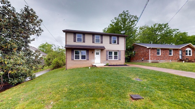 traditional-style house with a front lawn and brick siding