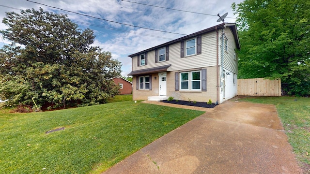 view of front facade with a front yard, fence, concrete driveway, and brick siding