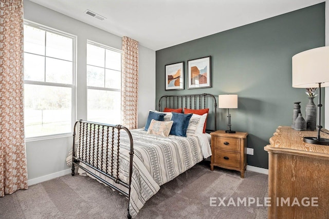 bedroom with baseboards, visible vents, and carpet flooring