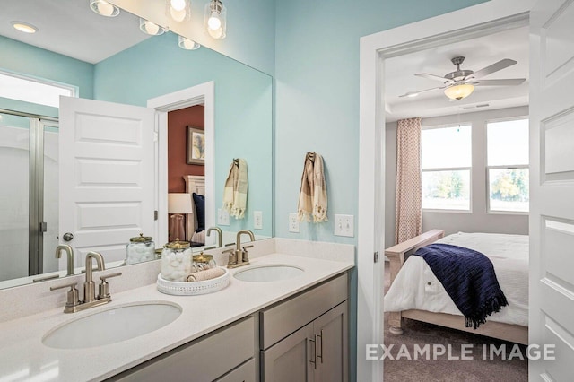 ensuite bathroom featuring double vanity, a sink, ceiling fan, and ensuite bath