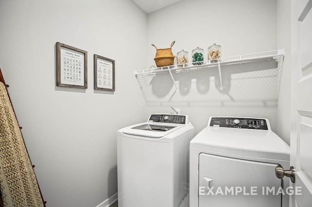 clothes washing area with washer and dryer and laundry area