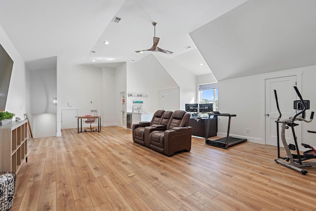 living room with baseboards, vaulted ceiling, light wood-style flooring, and visible vents