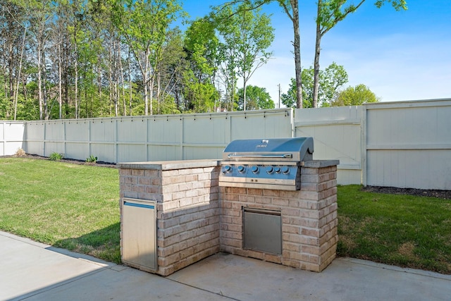 view of patio with fence, grilling area, and area for grilling