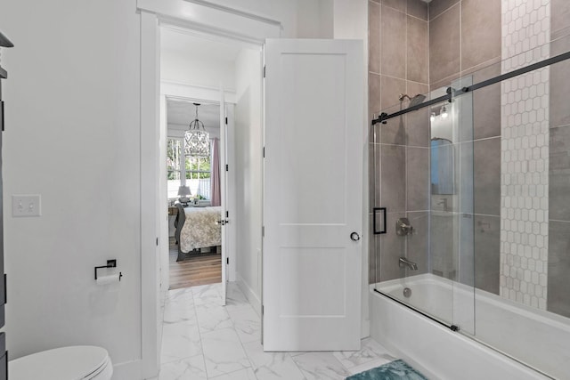 ensuite bathroom featuring marble finish floor, toilet, ensuite bathroom, a chandelier, and combined bath / shower with glass door