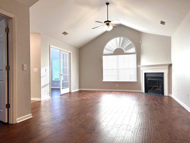 unfurnished living room with a glass covered fireplace, ceiling fan, visible vents, and dark wood finished floors