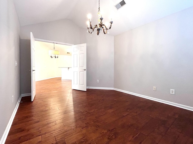 empty room with baseboards, dark wood-style floors, visible vents, a notable chandelier, and lofted ceiling