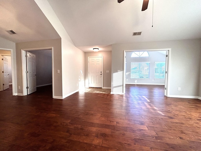 unfurnished living room featuring baseboards, visible vents, ceiling fan, and dark wood-style flooring