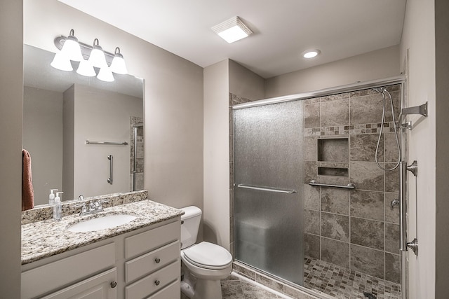 bathroom with recessed lighting, a shower stall, vanity, tile patterned floors, and toilet