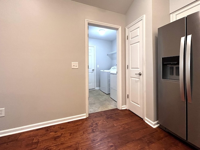 interior space featuring dark wood finished floors, baseboards, and separate washer and dryer