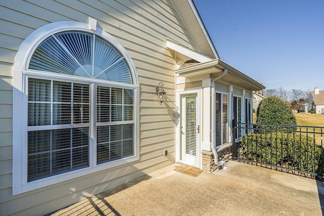 view of patio featuring fence