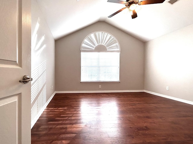 unfurnished room featuring baseboards, wood finished floors, a ceiling fan, and lofted ceiling