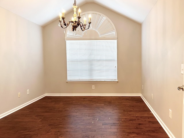 empty room featuring dark wood finished floors, baseboards, a notable chandelier, and lofted ceiling