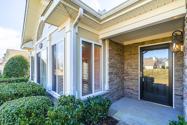 entrance to property featuring stone siding